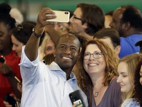 Florida Democratic gubernatorial candidate Andrew Gillum takes a photo with supporters during a campaign rally with U.S. Sen. Bill Nelson, D-Fla., Monday, Oct. 22, 2018, at the University of South Florida in Tampa, Fla.