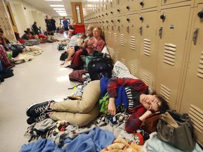 Emily Hindle lies on the floor at an evacuation shelter set up at Rutherford High School, in advance of Hurricane Michael, which is expected to make landfall today, in Panama City Beach, Fla., Wednesday, Oct. 10, 2018.