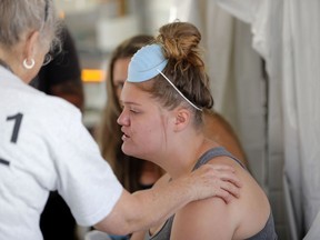 Aleeah Racette receives medical treatment inside the Florida 5 Disaster Medical Assistance Team tent, outside the Bay Medical Sacred Heart hospital, in the aftermath of Hurricane Michael in Mexico Beach, Fla., Thursday, Oct. 18, 2018.
