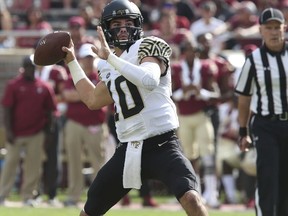 Wake Forest's Sam Hartman attempts a pass in the first quarter of an NCAA college football game with Florida State, Saturday, Oct. 20, 2018 in Tallahassee, Fla.
