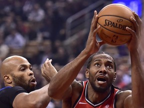 Toronto Raptors forward Kawhi Leonard (2) drives to the basket as Minnesota Timberwolves forward Taj Gibson (67) defends during first half NBA action in Toronto on Wednesday, Oct. 24, 2018.