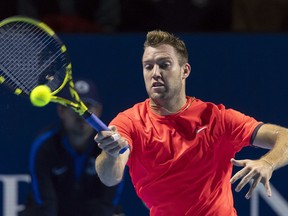 America's Jack Sock returns a ball to Latvia's Ernests Gulbis during their first round match at the Swiss Indoors tennis tournament at the St. Jakobshalle in Basel, Switzerland, on Wednesday, Oct. 24, 2018.