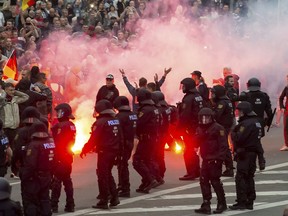 In this Aug. 27, 2018 photo protesters light fireworks during a far-right demonstration in Chemnitz, Germany.