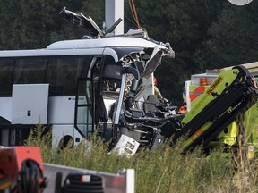The accident site of a bus that crashed into signal post on the highway A2 in Sigirino, canton of Ticino, Switzerland, Sunday, Oct. 14, 2018. The A2 highway between Rivera and Lugano-North in is closed to the south. Several people were injured in the accident.