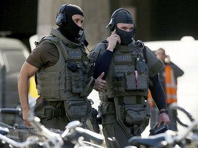 Special police operate outside the Cologne, western Germany,  train station Monday, Oct. 15, 2018. Cologne police closed parts of the western German city's main train station after a man took a woman hostage in a pharmacy inside.