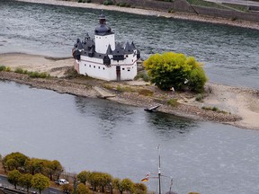In this Wednesday, Oct.24, 2018 photo the Pfalzgrafenstein castle from the 14th century sits on a sandbank in the river Rhine in Kaub, Germany, during historically low water levels. A hot, dry summer has left German waterways at record low levels, causing chaos for the inland shipping industry, environmental damage and billions of euros of losses _ a scenario that experts warn could portend things to come as global temperatures rise.