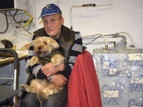 Ferenc Ribeny and his dog Mazli (Fluke) sit at a homeless shelter in Budapest, Hungary, Sunday Oct. 14, 2018. A constitutional ban on living in public areas goes into effect on Oct. 15, threatening the homeless with possible jail terms if they refuse to heed police warnings to stop living rough.