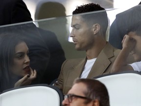 Juventus forward Cristiano Ronaldo and his partner Georgina sit in the stands prior to the Champions League, group H soccer match between Juventus and Young Boys, at the Allianz stadium in Turin, Italy, Tuesday, Oct. 2, 2018.
