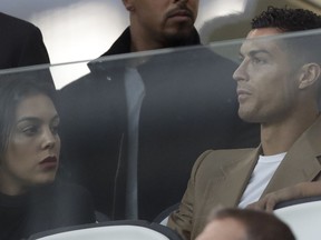 Juventus forward Cristiano Ronaldo and his partner Georgina sit in the stands prior to the Champions League, group H soccer match between Juventus and Young Boys, at the Allianz stadium in Turin, Italy, Tuesday, Oct. 2, 2018.