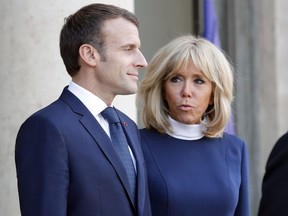 French president Emmanuel Macron and his wife Brigitte Macron wait for the arrival of Chile's President Sebastian Pinera and his wife Cecilia Morel prior to their meeting at the Elysee Palace in Paris, France, Monday, Oct. 8, 2018.