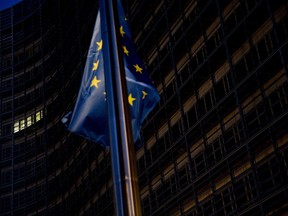 A European Union flag flies outside the European Commission headquarters in Brussels, Sunday, Oct. 14, 2018. Britain's Brexit secretary and the top European Union negotiator met for surprise talks Sunday and ambassadors from the 27 remaining EU countries gathered for a hastily scheduled discussion as the push for progress on a divorce deal quickened ahead of a vital summit.