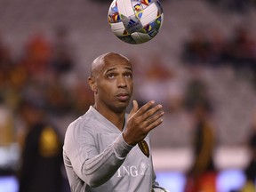 Belgium assistant coach Thierry Henry plays with a ball prior the UEFA Nations League soccer match between Belgium and Switzerland at the King Baudouin stadium in Brussels, Friday, Oct. 12, 2018.