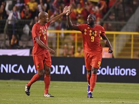 Belgium's Romelu Lukaku, right, celebrates with teammate Vincent Kompany after scoring his side's second goal during the UEFA Nations League soccer match between Belgium and Switzerland at the King Baudouin stadium in Brussels, Friday, Oct. 12, 2018.