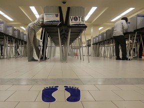 File - In this Nov. 8, 2016, file photo, voters cast ballots at City Hall in San Francisco. San Francisco will become the first city in California and one of only a handful nationwide to allow noncitizens to vote in a local election in November. They're only allowed to vote in the school board race.