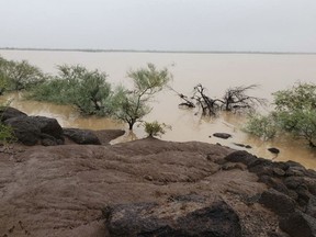 In this Oct. 2, 2018 photo provided by the Tohono O'odham Nation Dept. of Public Safety, is flooding near the Menagers Dam community in Arizona. An earthen dam in Arizona's southern desert could fail because the lake behind it is swollen with runoff from the remnants of Tropical Storm Rosa, threatening a small Native American community that is working to evacuate residents. (Tohono O'odham Nation Dept. of Public Safety via AP)