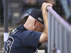 Atlanta Braves manager Brian Snitker pauses while watching from the dugout during the team's 6-0 loss to the Los Angeles Dodgers in Game 1 of a baseball National League Division Series, Thursday, Oct. 4, 2018, in Los Angeles.