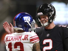 Atlanta Falcons quarterback Matt Ryan, right, and New York Giants wide receiver Odell Beckham Jr. greet each other on the field before facing off in an NFL football game Monday, Oct. 22, 2018, in Atlanta.