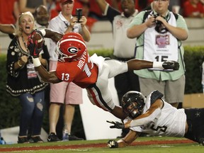 Georgia running back Elijah Holyfield (13) dives into the end zone for a touchdown as Vanderbilt safety LaDarius Wiley