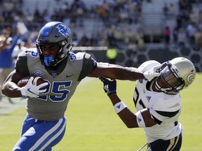 Duke running back Deon Jackson (25) stiff arms Georgia Tech defensive back Jaytlin Askew (33) as he runs for a touchdown during the first half of an NCAA college football game, Saturday, Oct. 13, 2018, in Atlanta.