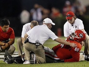 Georgia offensive lineman Solomon Kindley (66) is tended to by the medical staff after being injured during the first half of an NCAA college football game against Vanderbilt on Saturday, Oct. 6, 2018, in Atlanta.