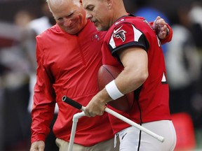 Tampa Bay Buccaneers defensive coordinator Mike Smith speaks with Atlanta Falcons kicker Matt Bryant ahead of an NFL football game, Sunday, Oct. 14, 2018, in Atlanta.