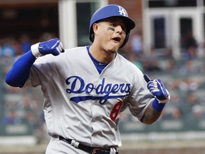 Los Angeles Dodgers' Manny Machado (8) celebrates his three-run homer against the Atlanta Braves during the seventh inning in Game 4 of baseball's National League Division Series, Monday, Oct. 8, 2018, in Atlanta.