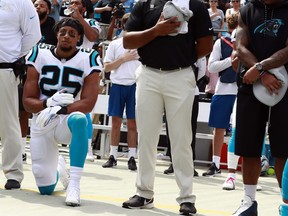 Carolina Panthers' Eric Reid (25) kneels during the national anthem before an NFL football game against the New York Giants in Charlotte, N.C., Sunday, Oct. 7, 2018.
