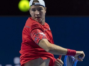 Germany's Jan-Lennard Struff returns a ball to Australia's John Millman during their first round match at the Swiss Indoors tennis tournament at the St. Jakobshalle in Basel, Switzerland, on Tuesday, October 23, 2018.