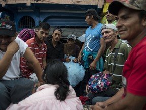 Honduran migrants ride on the bed of a pick-up truck towards the Mexican border, in Mazatenango, about 200 miles north-west from Guatemala City, Guatemala, Thursday, Oct. 18, 2018. Many of the more than 2,000 Hondurans in a migrant caravan trying to wend its way to the United States left spontaneously with little more than the clothes on their backs and what they could quickly throw into backpacks.