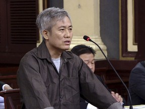 Luu Van Vinh stands trial in Ho Chi Minh City, Vietnam, Friday, Oct. 5, 2018. Vinh and four others were sentenced between eight to 15 years in prison for attempting to overthrow the government.