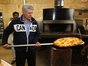 Prime Minister Stephen Harper makes pizza in Woodbridge on Tuesday September 29, 2015.