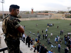 A Lebanese soldier stands guard as Lebanese Foreign Minister Gebran Bassil tours a soccer club, with diplomats and journalists, one of several locations they visited near Beirut's international airport, in Beirut, Lebanon, Monday, Oct. 1, 2018. The ministry-organized tour, including a Golf course and the soccer club, was an effort to dispel Israeli allegations of the presence of missile sites there.