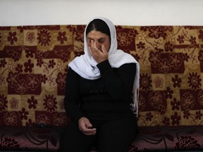 In this Thursday, Oct. 4, 2018 photo, Maysoun Saab, 39, who lost her mother, father, brother as well as 34 members of her extended family in a July 25 Islamic State attack, cries as speaks during an interview with The Associated Press in the her house at the village of Shreihi in the southern province of Sweida, Syria. Three months after a stunning Islamic State attack on a southeastern corner of Syria in which more than 200 people were killed and 30 women and children abducted, tensions are boiling over, and young men are taking up arms. It is a stark change for a province that managed to stay on the sidelines of the seven-year Syrian war and where most villagers worked grazing livestock over surrounding hills.