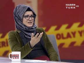 In this image from TV, Hatice Cengiz, reacts during an interview on Turkish television channel HaberTurk, Friday Oct. 26, 2018, about the day her fiancee Saudi writer Jamal Khashoggi entered the Saudi Arabia Consulate on Oct. 2, and was killed inside.  Hatice Cengiz said "I found myself in a darkness I cannot express", and talked about when Khashoggi had gone to the consulate for paperwork related to his planned marriage to Cengiz.