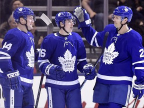 Mitchell Marner (16) celebrates with defencemen Morgan Rielly (44) and Ron Hainsey (2) after scoring against the Florida Panthers last March. THE CANADIAN PRESS/Frank Gunn