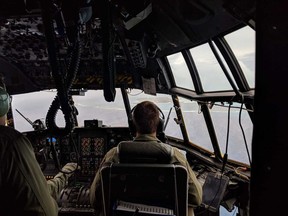 This Monday, Oct. 1, 2018 photo provided by the U.S. Coast Guard shows a HC-130 Hercules aircraft approaching Johnston Atoll to evacuate four wildlife refuge workers before Hurricane Walaka arrives at the remote Pacific island. The Coast Guard said Tuesday one of its Hawaii planes picked up the Fish and Wildlife Service workers from Johnston Atoll on Monday.