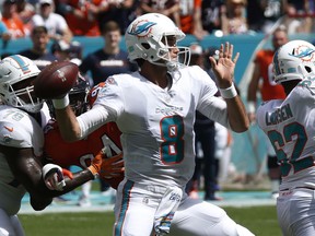 Miami Dolphins quarterback Brock Osweiler (8) looks to pass, during the first half of an NFL football game against the Chicago Bears, Sunday, Oct. 14, 2018, in Miami Gardens, Fla.