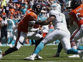 Miami Dolphins defensive end Jonathan Woodard (76) sacks Chicago Bears quarterback Mitchell Trubisky (10), during the first half of an NFL football game, Sunday, Oct. 14, 2018, in Miami Gardens, Fla.