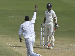 West Indies' Jason Holder celebrates the dismissal of India's Ajinkya Rahane during the third day of the second cricket test match between India and West Indies in Hyderabad, India, Sunday, Oct. 14, 2018.