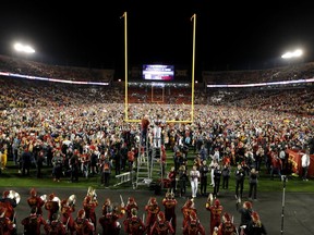 Iowa State fans celebrate on the field after an NCAA college football game against West Virginia, Saturday, Oct. 13, 2018, in Ames, Iowa.