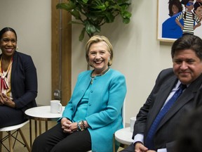 Former U.S. Secretary of State Hillary Clinton, center, Illinois gubernatorial candidate J.B. Pritzker and his running mate Juliana Stratton participate in a roundtable discussion with 10 female high school students from across Chicago about the importance of leadership at EvolveHer, Monday, Oct. 1, 2018.