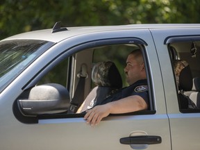 In this photo made Wednesday, Sept. 19, 2018, a security guard sits in a vehicle outside the North Alton Confederate Cemetery in Alton, Ill. The federal government has hired private security firms to guard several Confederate memorials across the U.S in the aftermath of clashes between white nationalists and counter-protesters last year. Information obtained by The Associated Press shows that nearly $3 million has been spent on contracted security since last summer and another $1.6 million is budgeted for similar protection in fiscal 2019.