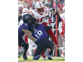 Nebraska's Mike Williams (19) is tackled by Northwestern's Blake Gallagher (51) and Northwestern's Cameron Ruiz during the first half of an NCAA college football game Saturday, Oct. 13, 2018, in Evanston, Ill..