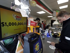 A sign displays the estimated Mega Millions jackpot at a convenience store in Chicago, Friday, Oct. 19, 2018. Friday's jackpot has soared to $1 billion, the second-largest prize in U. S. lottery history.