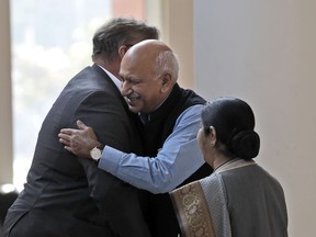 FILE - In this Nov. 24, 2017 file photo, Indian Junior Foreign Minister M.J. Akbar, center, hugs Finland's Foreign Minister Timo Soini in New Delhi, India. Akbar has resigned amid accusations by at least 15 women of sexual harassment during his previous career as a news editor.