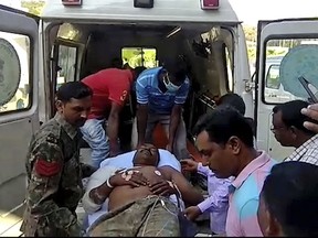 In this grab made from video provided by KK Productions, an Indian policeman injured in an ambush is taken on a stretcher out of an ambulance in Dantewada district, in Chhattisgarh state, India, Tuesday, Oct. 30, 2018.