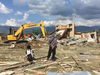 Heavy machinery digs through the ruins of a church to find bodies likely to be buried underneath in Jono Oge, Indonesia.