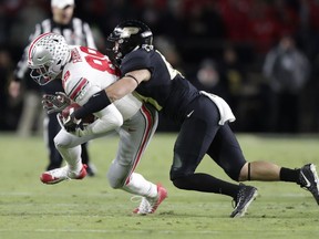 Purdue safety Jacob Thieneman (41) tackles Ohio State tight end Luke Farrell (89) during the first half of an NCAA college football game in West Lafayette, Ind., Saturday, Oct. 20, 2018.