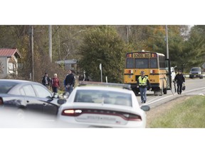 Emergency personnel responded to a scene of a collision that killed three children crossing SR 25 as they were boarding their school bus north of Rochester, Ind., on Tuesday, Oct. 30, 2018.