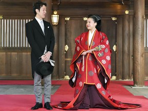 Japanese Princess Ayako, dressed in traditional ceremonial robe, and groom Kei Moriya speak to the reporters after their wedding ceremony at Meiji Shrine in Tokyo, Monday, Oct. 29, 2018.